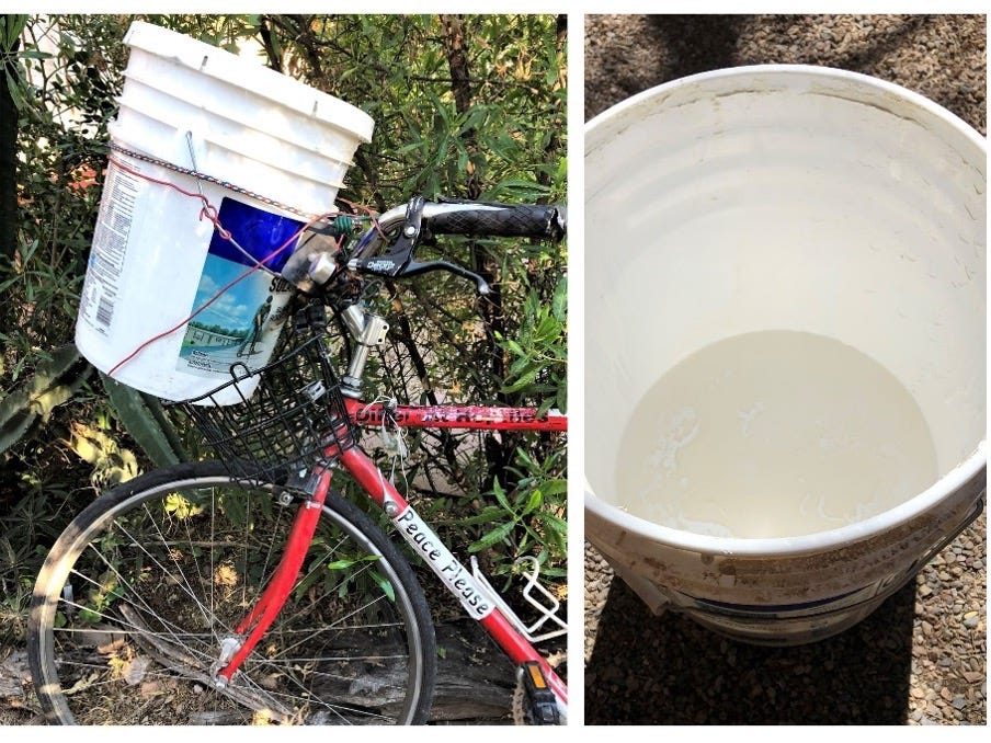 5-gallon bucket strapped to a bike basket