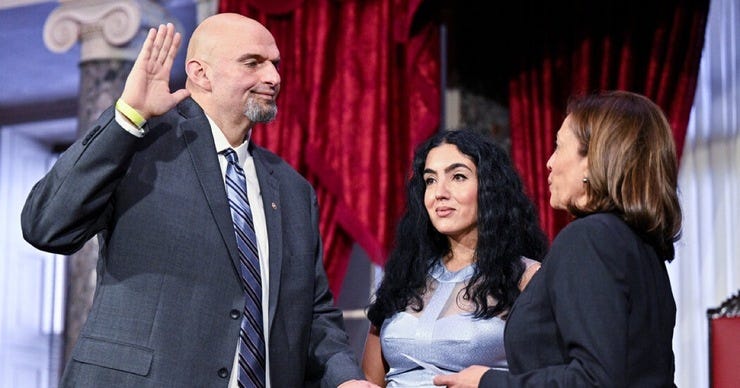The new Democratic Senator from Pennsylvania, a well suited John Fetterman, sworn in by the Vice President , with wife Gisela standing by.
