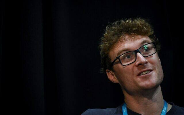 May be an image of 1 person, microphone and text