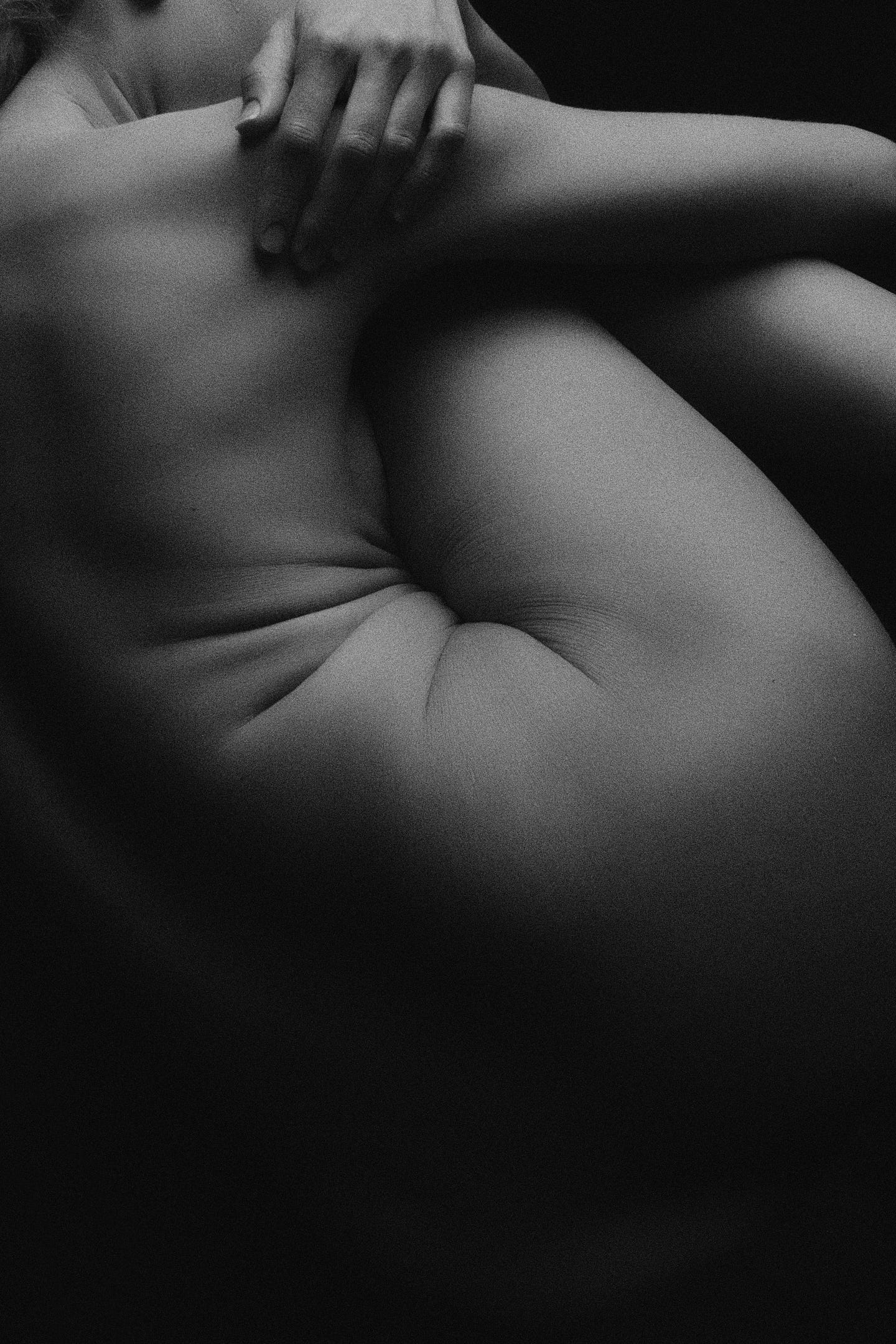 Nude woman curled up in fetal position Nude woman curled up in fetal position