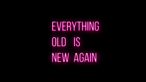 Neon pink sign againgst black background that says "Everything Old is New Again"