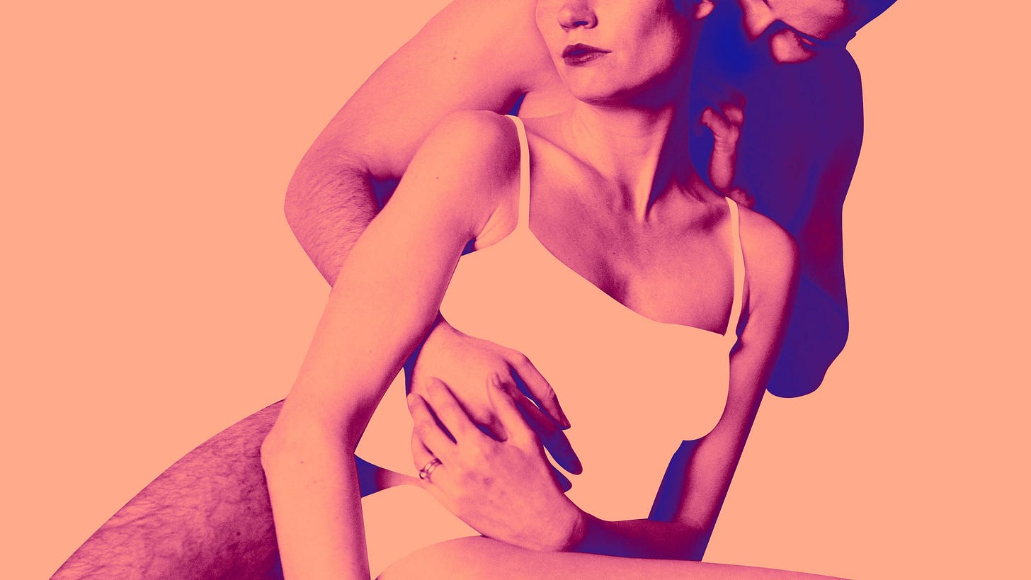 a man embraces a woman from behind
