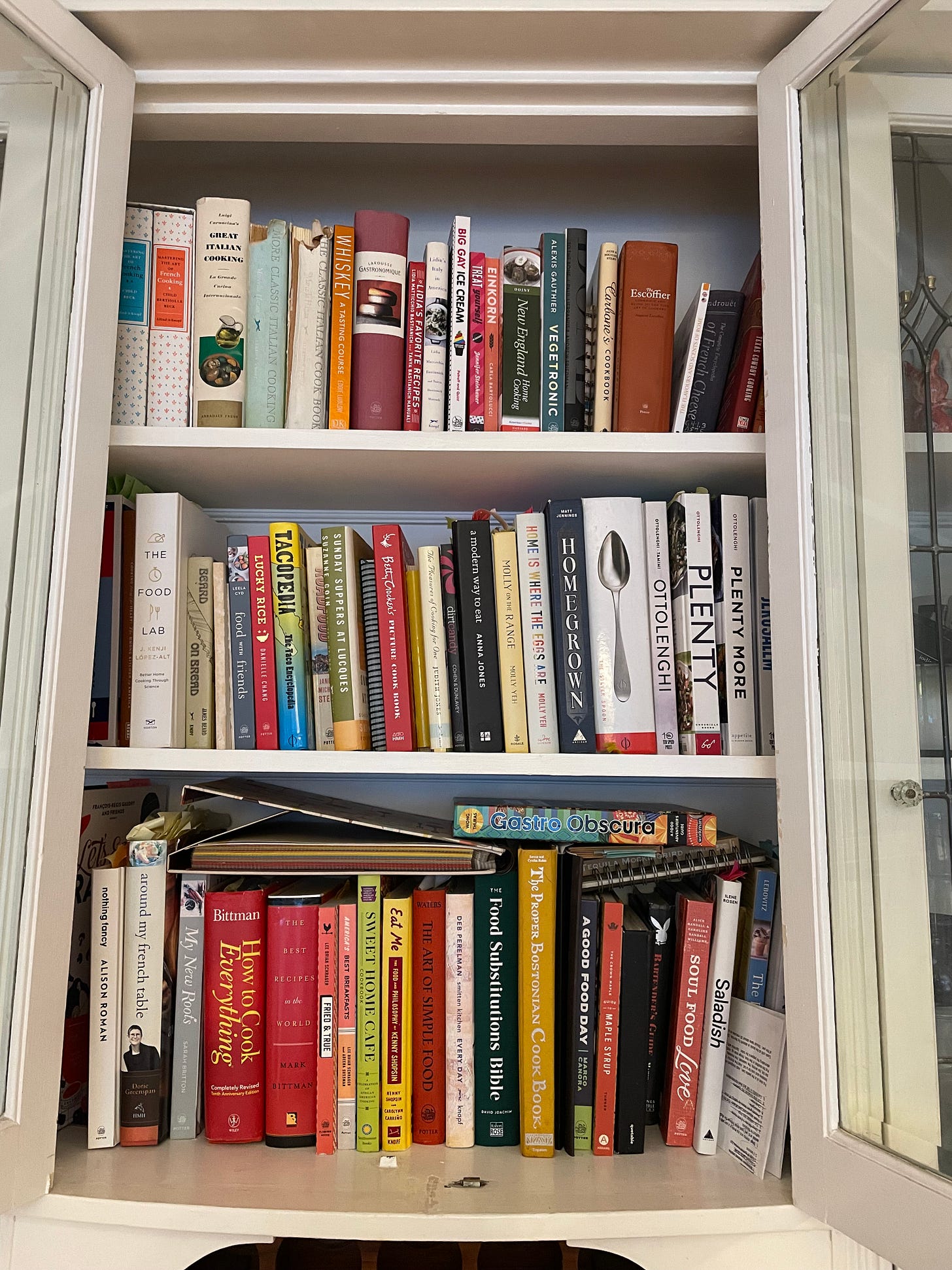 Three shelves of a cookbook collection in the author's home
