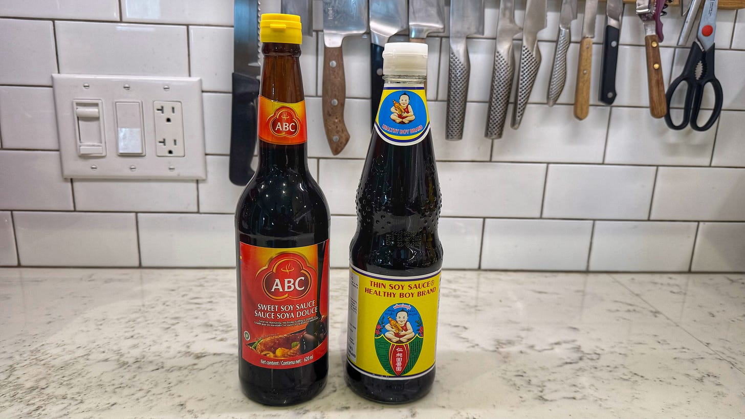 The two Southeast Asian soy sauces, standing next to each other on a kitchen counter