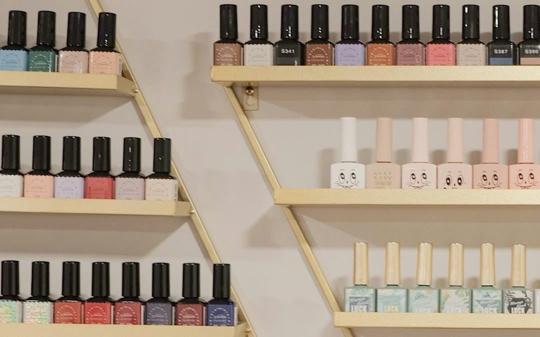 white and black bottles on brown wooden shelf