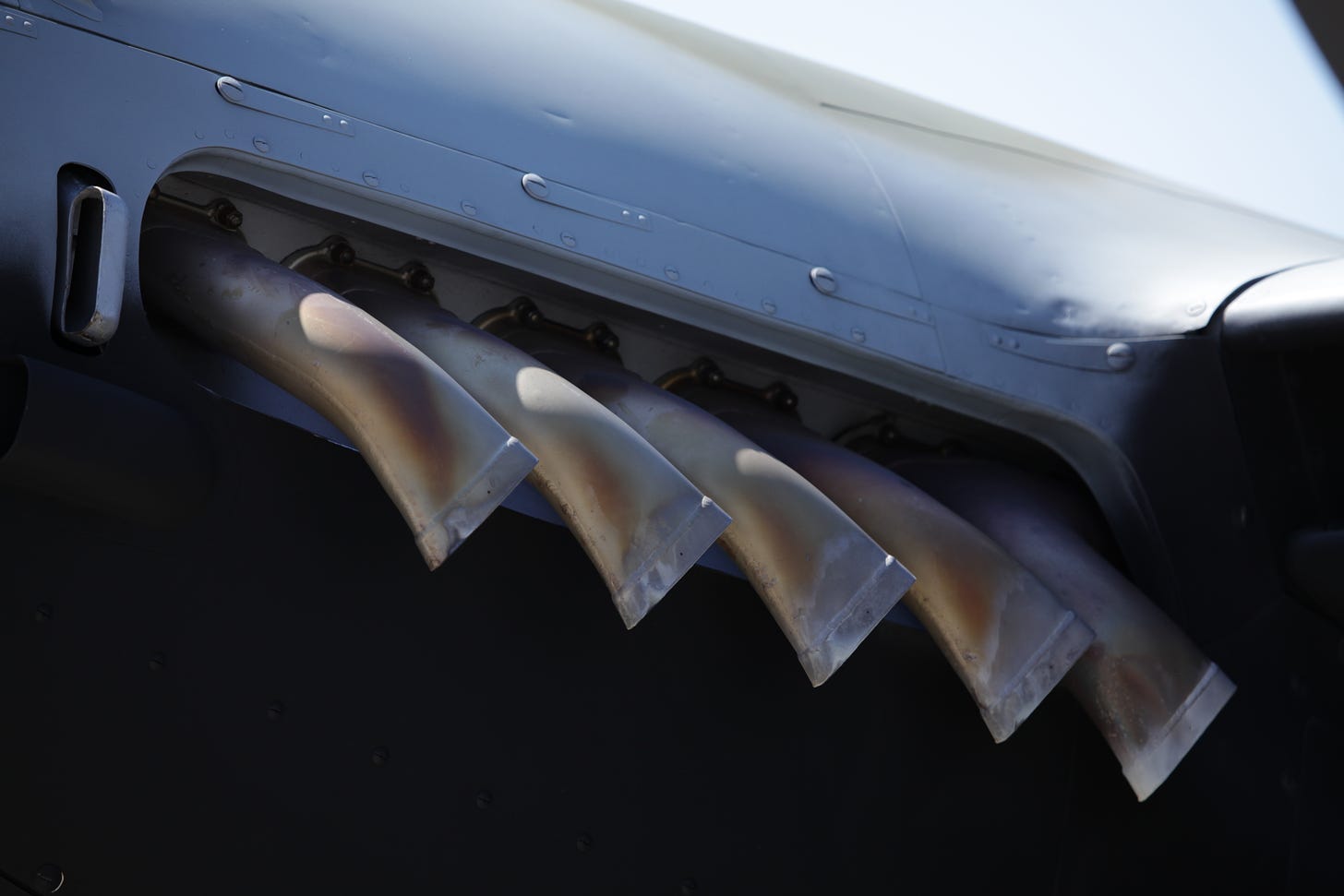 A close-up photograph of plane exhaust pipes.