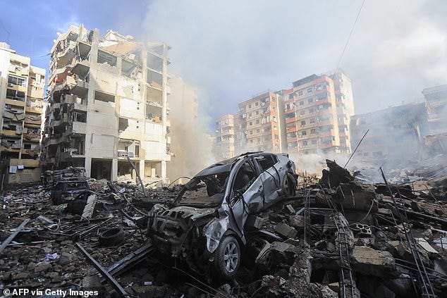 Smoke seeps out from building rubble at the site of an overnight Israeli airstrike on the Laylaki neighbourhood in Beirut's southern suburbs on October 1, 2024