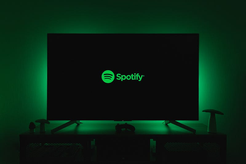 Spotify name and logo on an otherwise black computer screen.