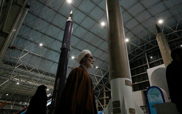 A cleric walks past Iranian domestically-built missiles as he visits National Aerospace Park of the Revolutionary Guard, just outside Tehran, Iran, November 15, 2024. (AP Photo/Vahid Salemi)