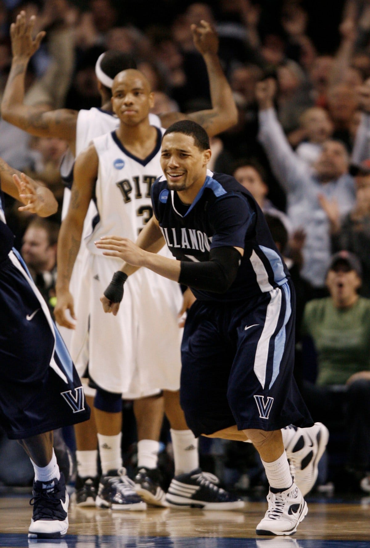 Villanova guard Scottie Reynolds (1) begins to celebrate his game-winning shot in front of Pittsburgh guard Jermaine Dixon (3) in the second half during a men's NCAA tournament regional championship college basketball game in Boston, Saturday, March 28, 2009. Villanova won 78-76 to advance to the Final Four. (AP Photo/Winslow Townson)