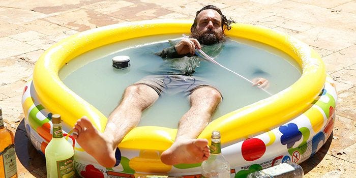 Phil lying in a margarita pool in The Last Man on Earth