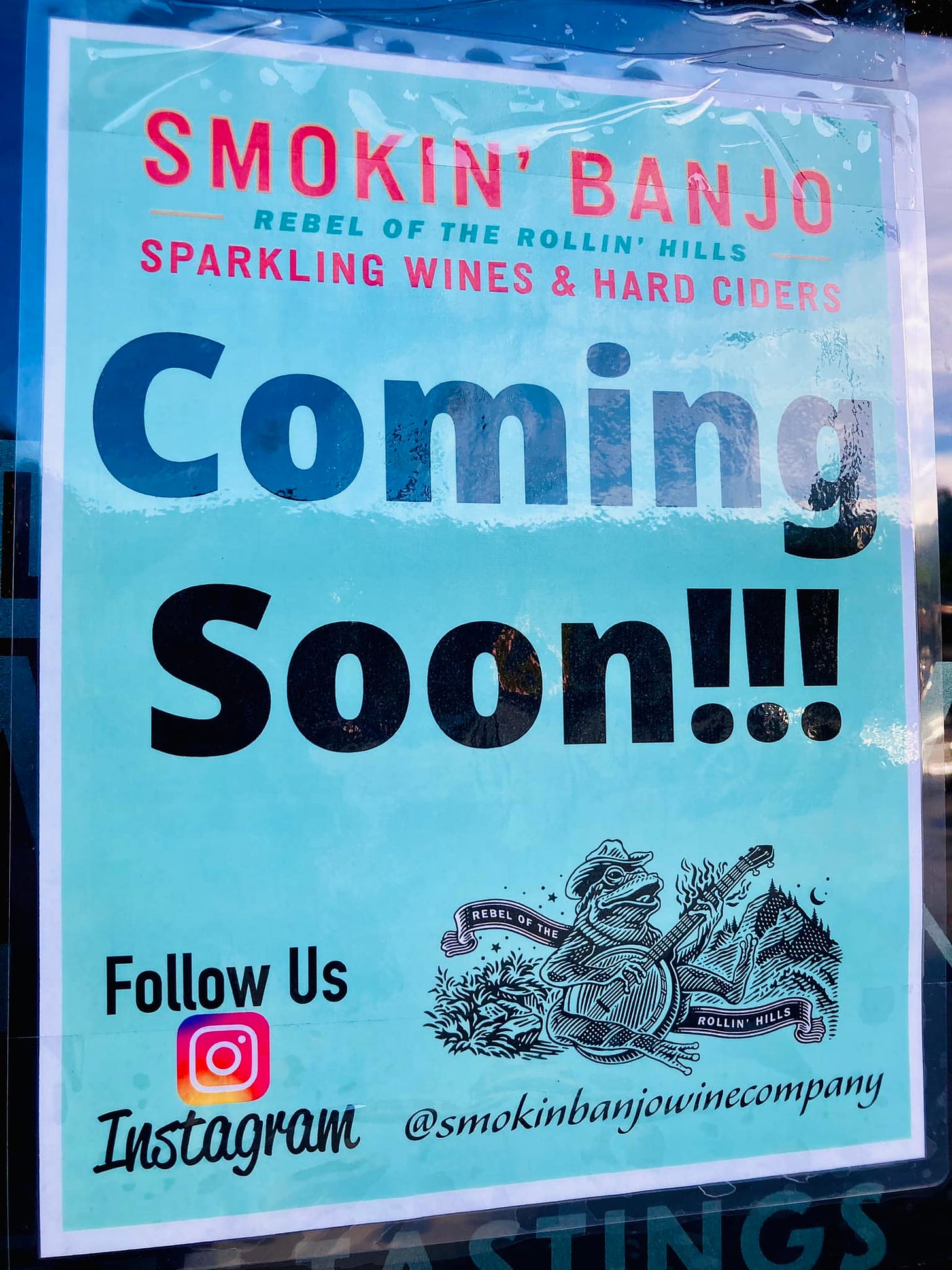 May be an image of text that says 'SMOKIN' REBEL OF THE ROLLIN' HILLS BANJO SPARKLING WINES & HARD CIDERS Comina Soon!!! Follow Us ROLLIN HILLS Instagram @smokinbanjowinecompany'