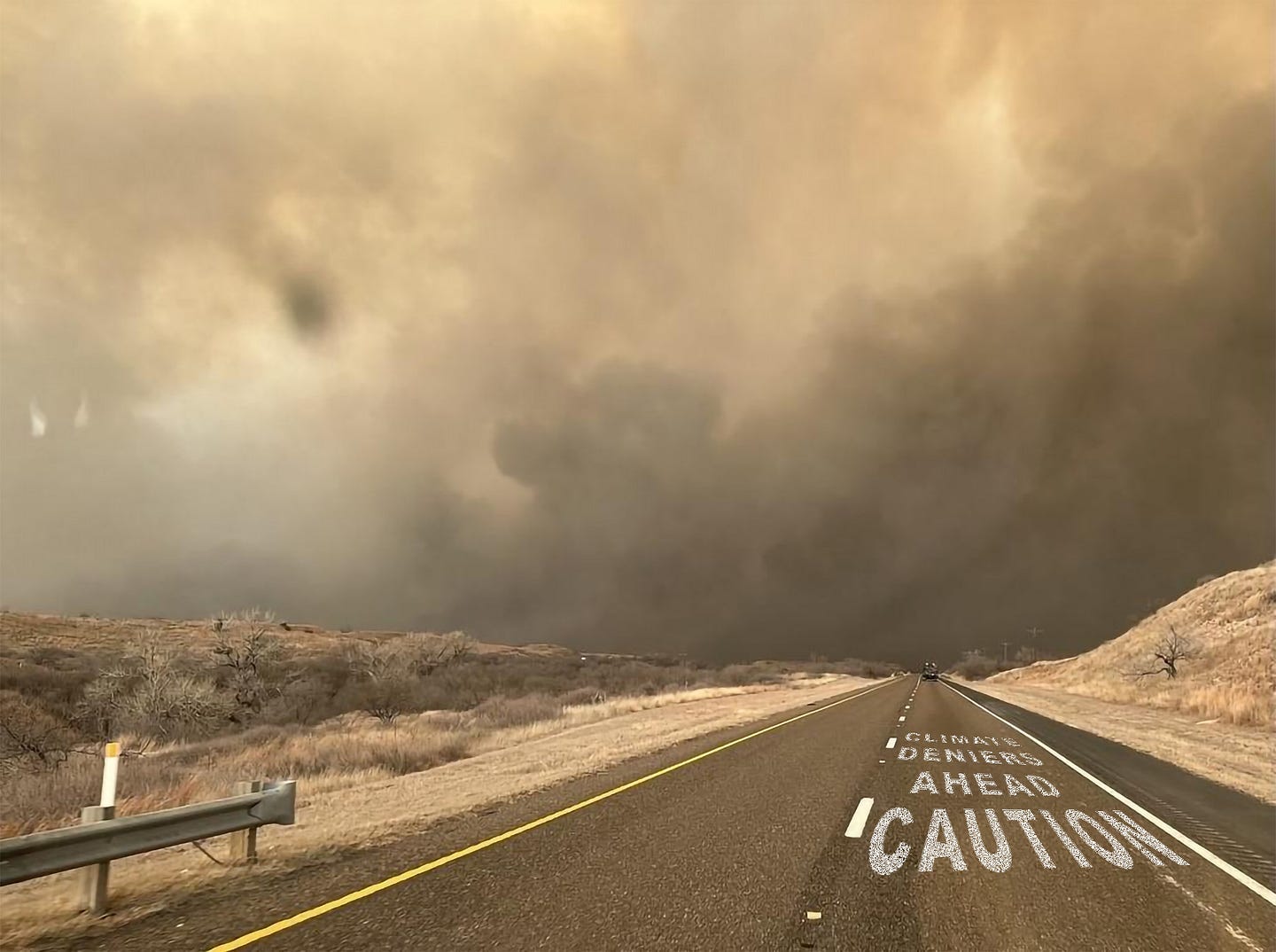 Photo of two lane country road leading to wildfire smoke. On the road is painted the words: Caution, climate deniers ahead.