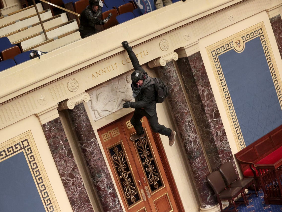Photos: Pro-Trump Rioters Seen Storming Capitol's Senate Chamber
