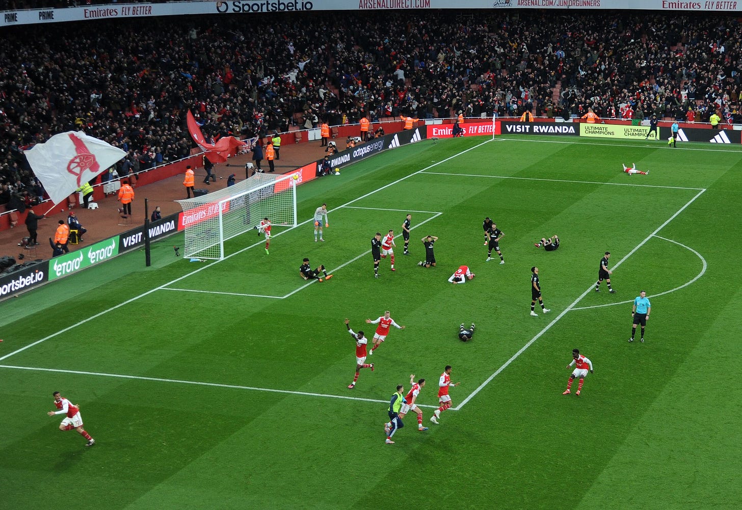 The Arsenal team celebrate after Reiss Nelson's winner against Bournemouth