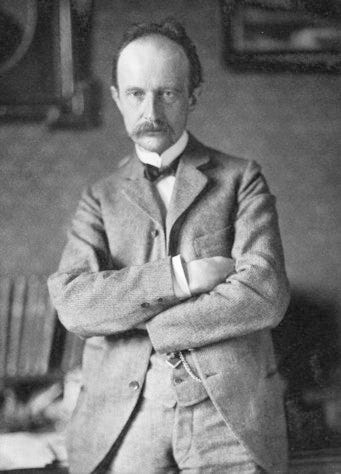 Max Planck with arms crossed