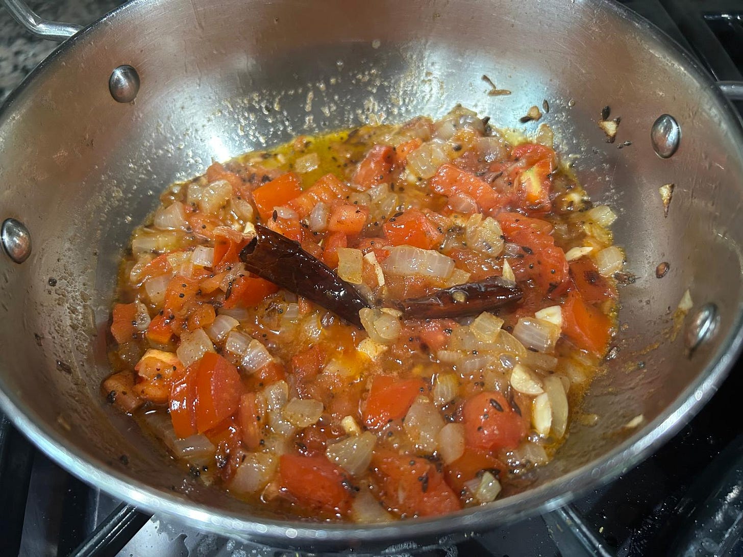 Onions, tomatoes, garlic breaking down in tadka