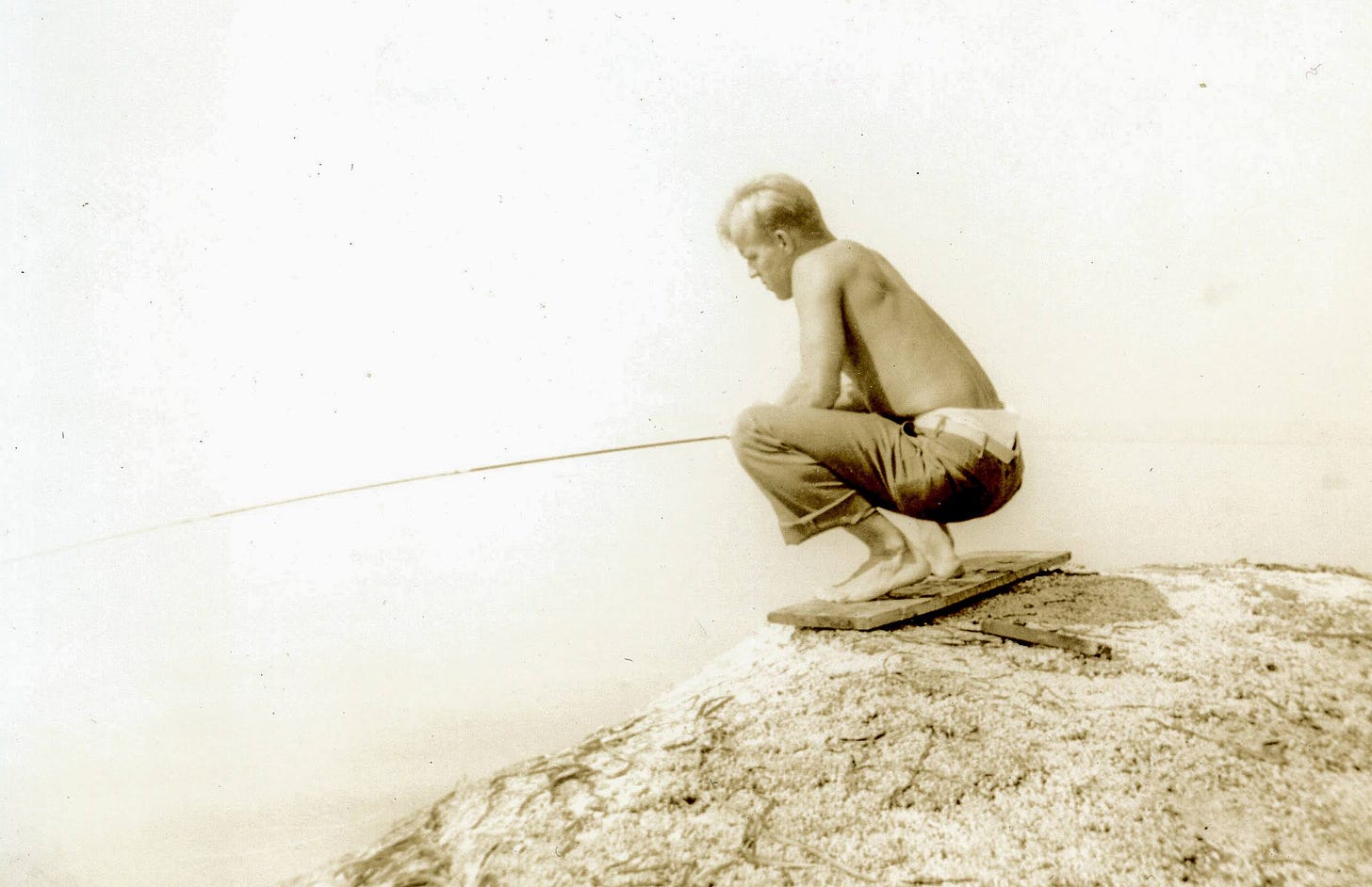 Man fishing from rock