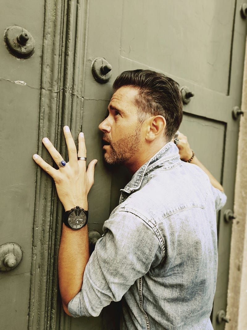 Man clinging to a door Man clinging to a door