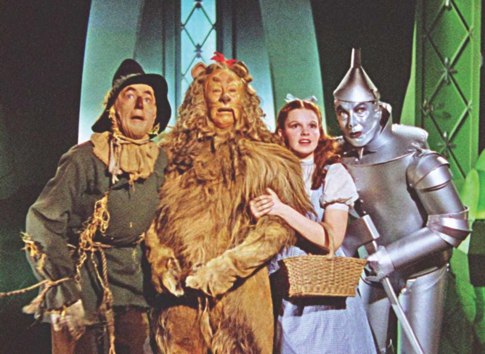 Scarecrow, Cowardly Lion, Dorothy, and Tin Man in MGM's The Wizard of Oz movie (1939).