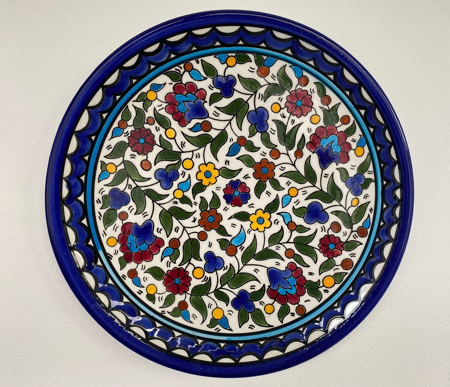 Photograph of a colorful plate with flower motifs. 
