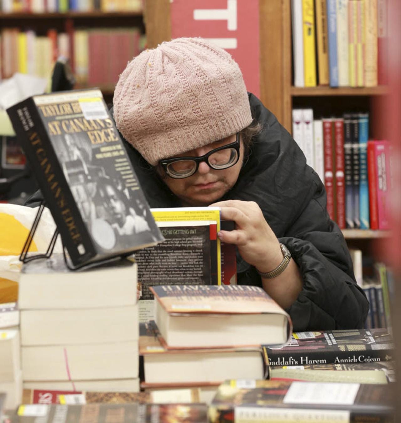 A woman browses books at Strand Book Store.