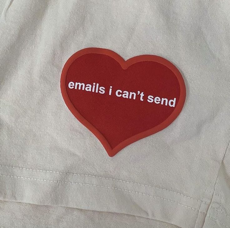 This may contain: a red heart with the words emails i can't send on it is attached to a white jacket