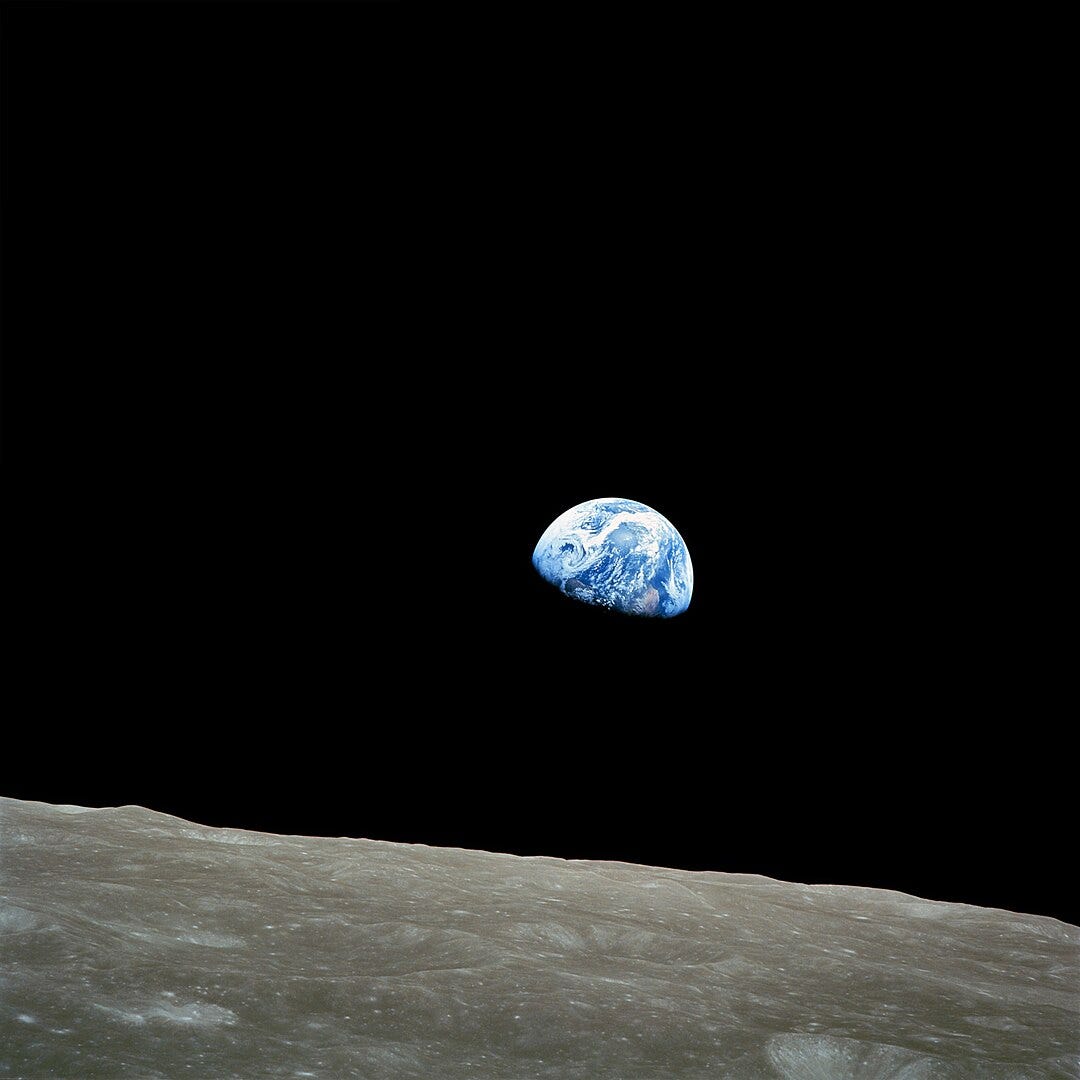 Earth rising above the surface of the moon