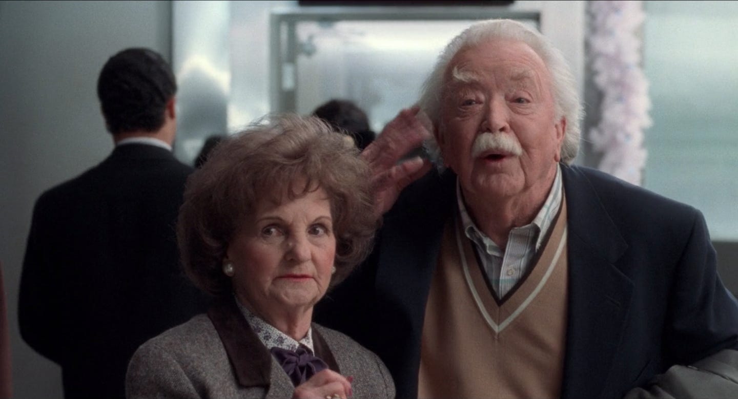 A screen grab from Home Alone featuring the old couple at the airport