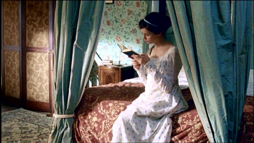Catherine Morland is reading a book in the bed of her chamber at Northanger Abbey. 