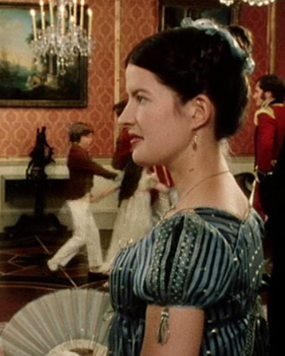 Charlotte Lucas in profile while attending a ball. 
