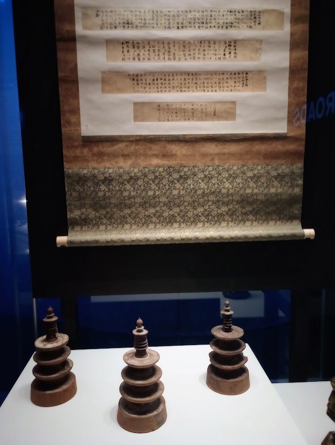 Mini wooden pagodas and examples of  scrolls from inside them