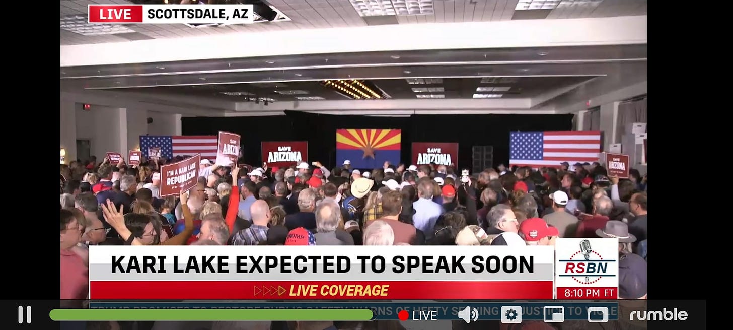 May be an image of one or more people and text that says 'LIVE SCOTTSDALE, AZ LAVE RZIN SAVE ARIZONA KARI LAKE EXPECTED TO SPEAK SOON LIVE COVERAGE RSBN LIVE 8:10PM T rumble'