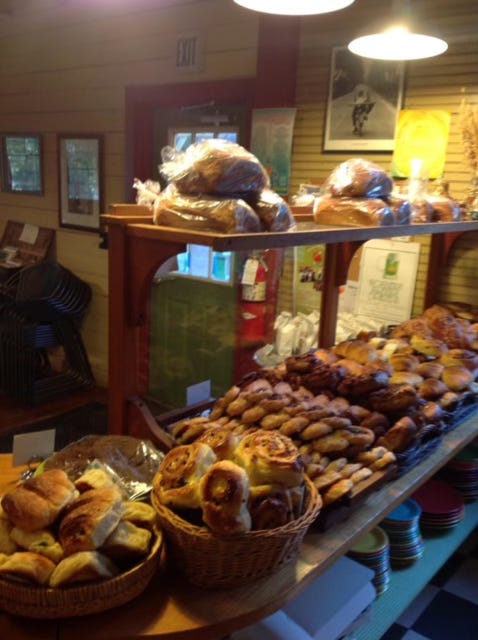 Interior of the bakery showcasing rolls, bread loaves, and other baked goods.