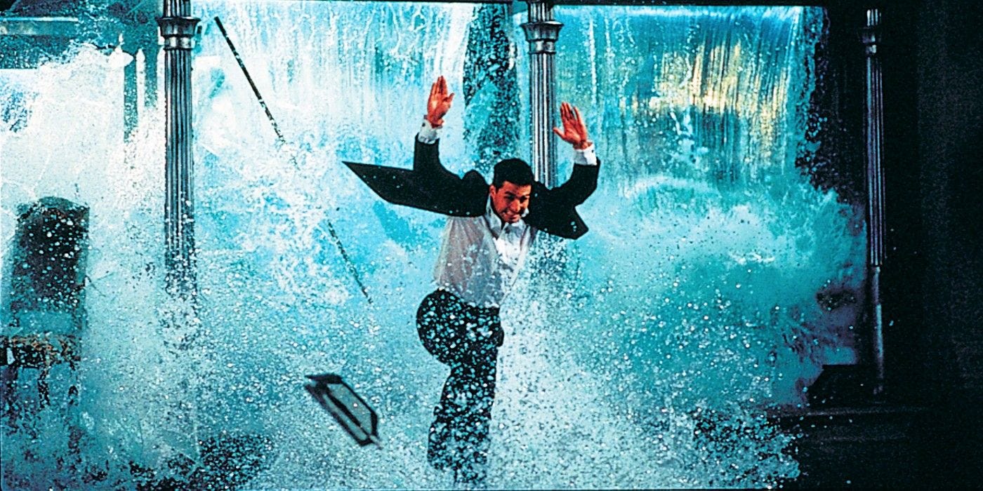 Young Tom Cruise jumping through a window while a water tank full of fish explodes behind him making it seem like he's jumping away from a waterfall. Young Tom Cruise jumping through a window while a water tank full of fish explodes behind him making it seem like he's jumping away from a waterfall.