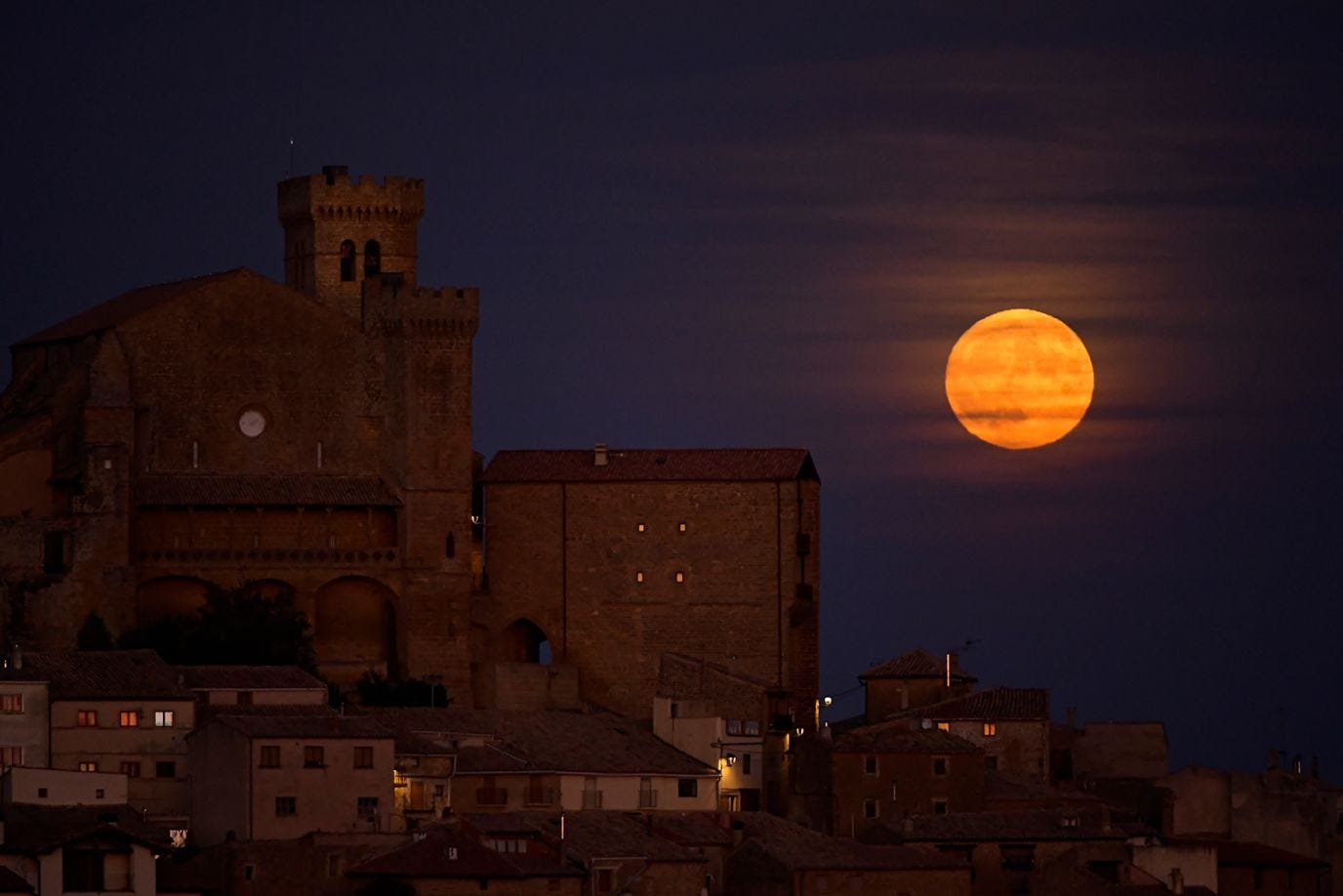 The super blue moon rises behind the small village of Ujue, northern Spain, on August 30.