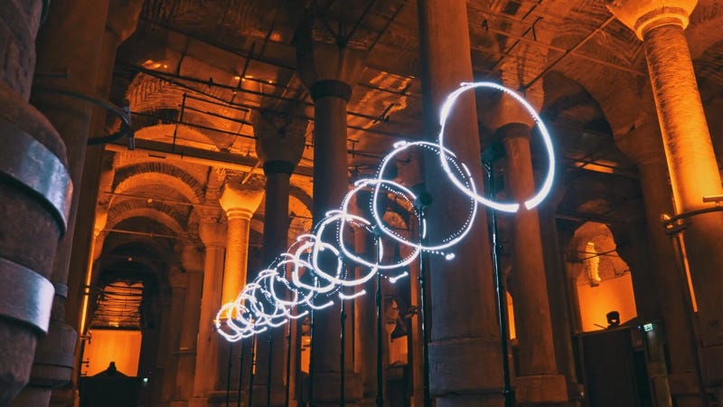 An art installation consisting of a row of circles of light suspended in the air in an old building. You get the distinct impression that the shape of those lights might change. 