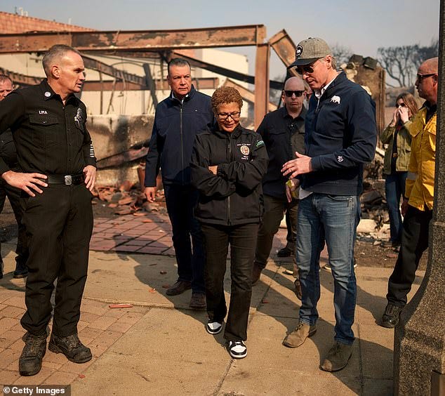 California Governor Gavin Newsom and Mayor Bass tour the downtown business district of Pacific Palisades after the devastating blaze on Tuesday. The Mayor has come under fire for her decision to cut around $17.5 million from the fire department budget this fiscal year