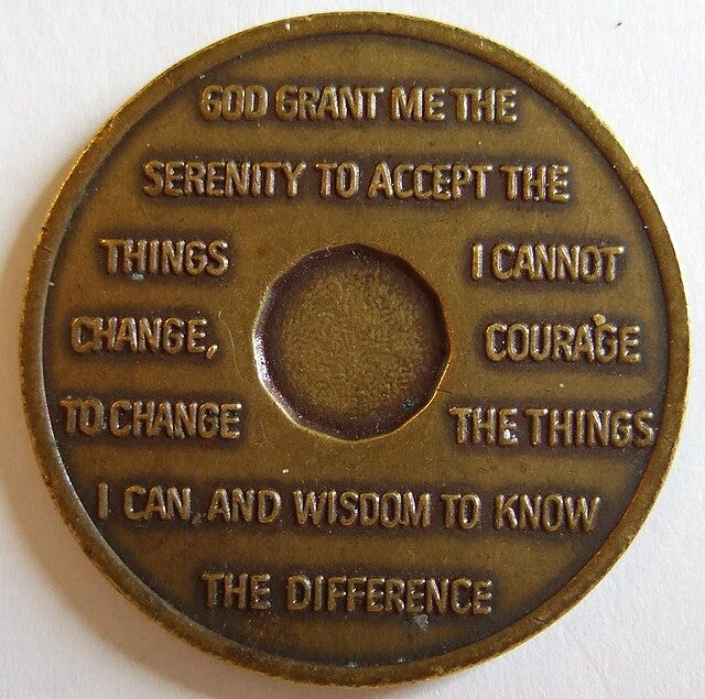 Photo of a medallion with the words to the serenity prayer engraved on it