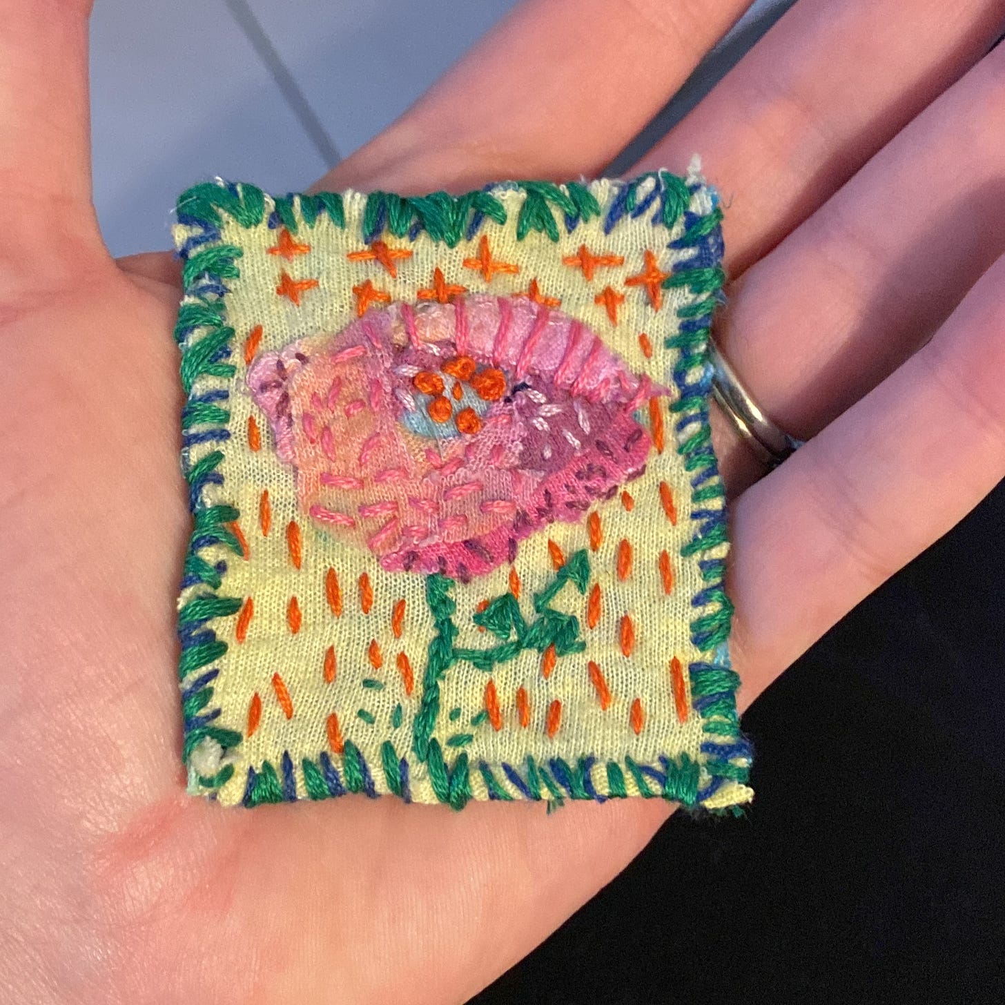 a small patch of an embroidered flower