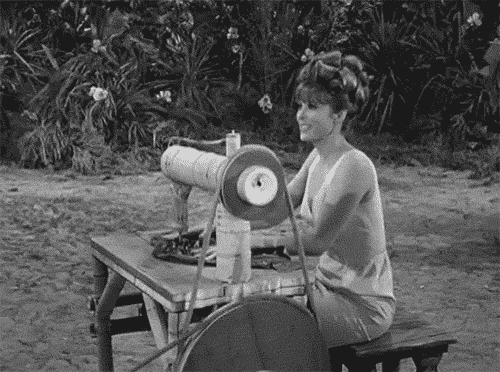 Ginger from Gilligan's Island sits on an island-made sewing machine