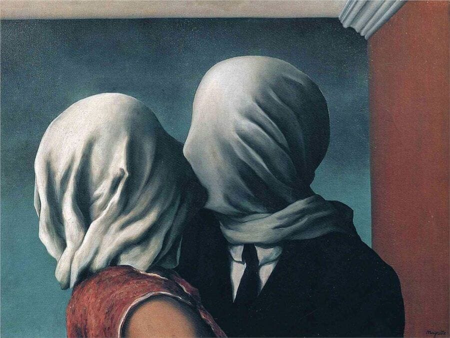 Two people, a man dressed in a suit and tie a woman possibly in a dress, with white cloths covering both of their heads separately. They are kissing.