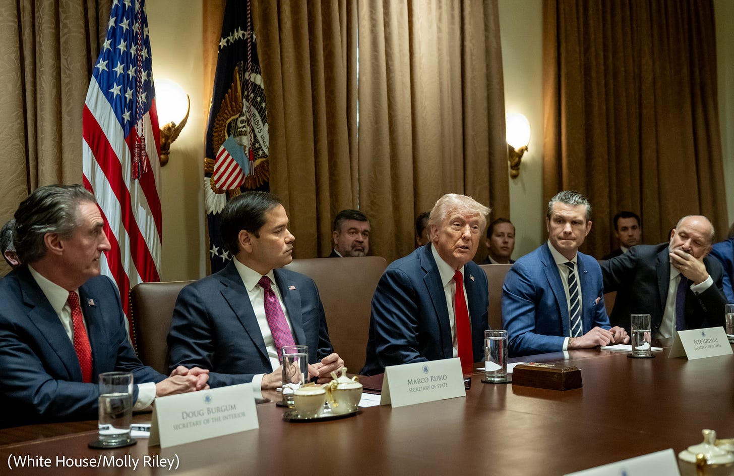 Cabinet meeting with President Trump, in a formal setting with officials seated around a large table, engaged in conversation Cabinet meeting with President Trump, in a formal setting with officials seated around a large table, engaged in conversation