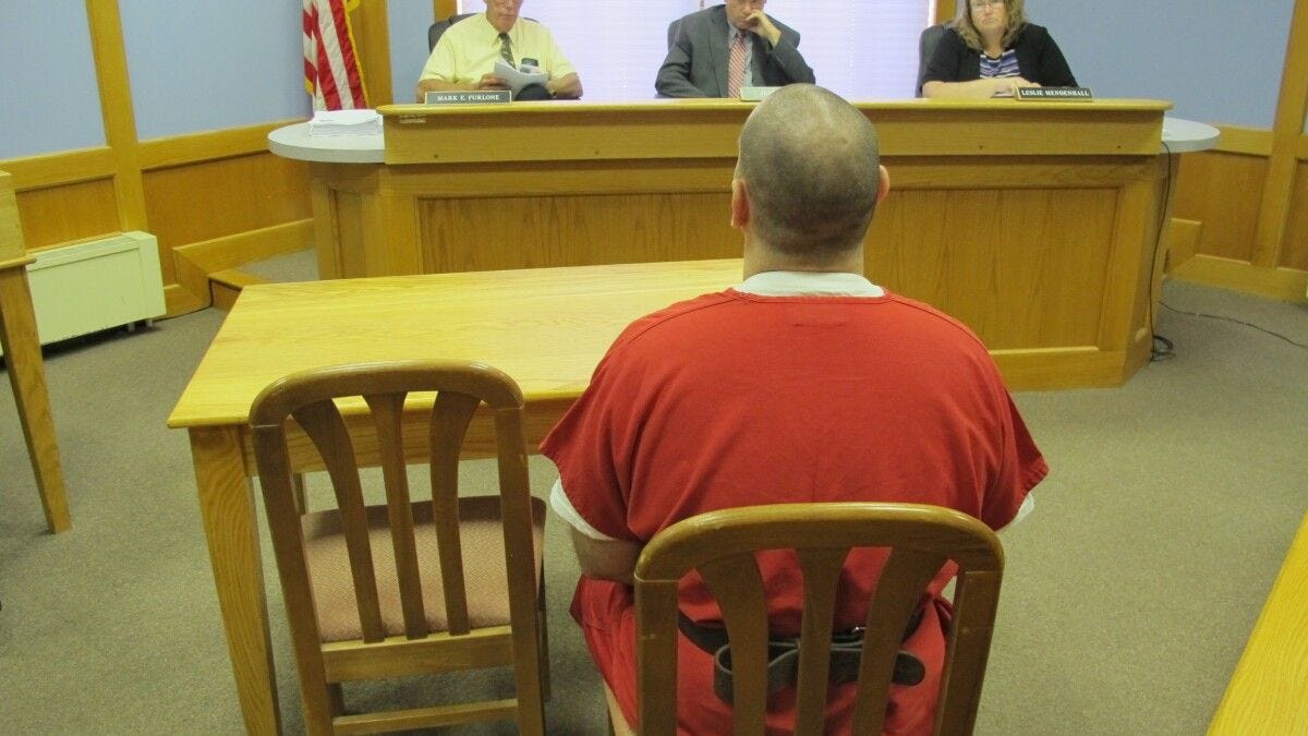 Inmates sit just a few feet from the bench at NH's Adult Parole Board hearings