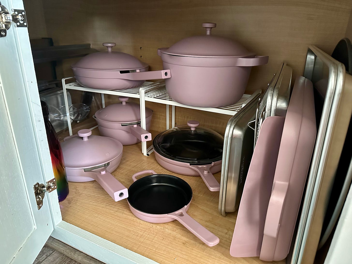 A peek in Shohreh's cupboard which shows a variety of Always pans and pots in lavender