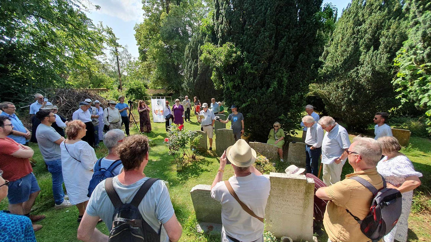 A shot of a crowd attending a reading by Richard Blair at the grave of his father Eric Arthur Blair aka Georg Orwell.