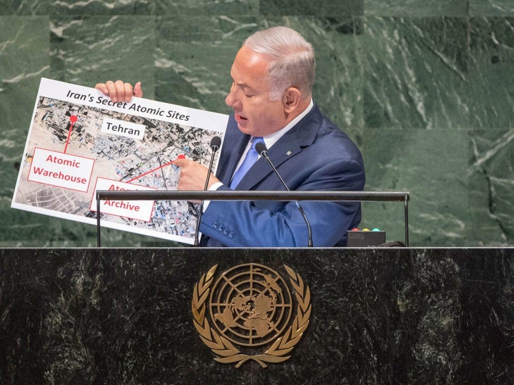 Netanyahu holding up some silly illustrations to the UN