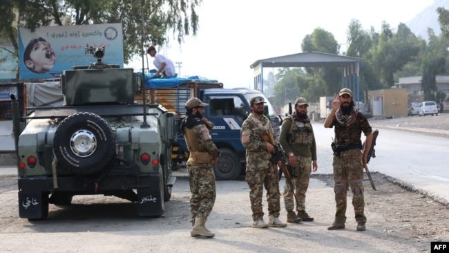 FILE - Taliban security personnel stand guard at the Pakistan-Afghanistan border in Torkham, Afghanistan, Sept. 15, 2023. Two Afghan insurgent groups claim to have killed at least 50 Taliban officials and soldiers during November. 