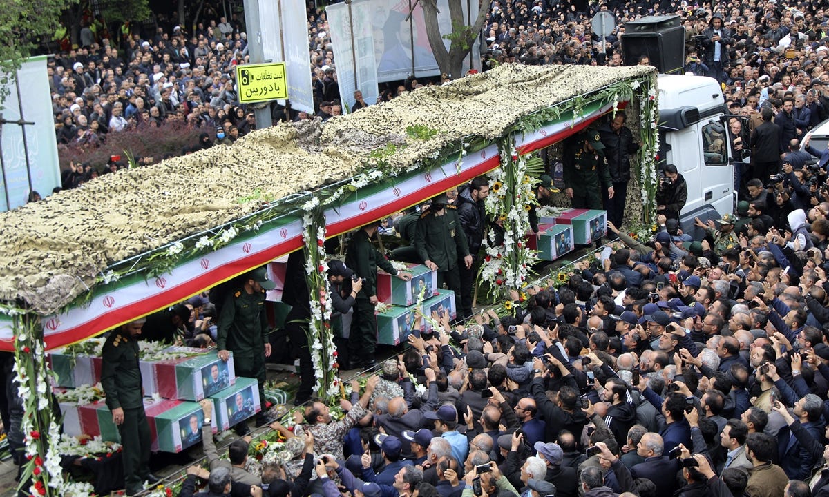 In this photo provided by Fars News Agency, mourners gather around a truck carrying the coffins of Iranian President Ebrahim Raisi and his companions who were killed when their helicopter crashed on May 19, 2024 in a mountainous region of the country's northwest, during a funeral ceremony at the city of Tabriz, Iran on May 21, 2024. Photo: VCG
