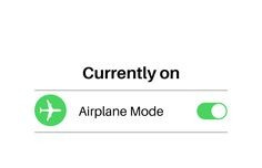 This may contain: an airport sign with the words currently on and airplane mode written below it in green